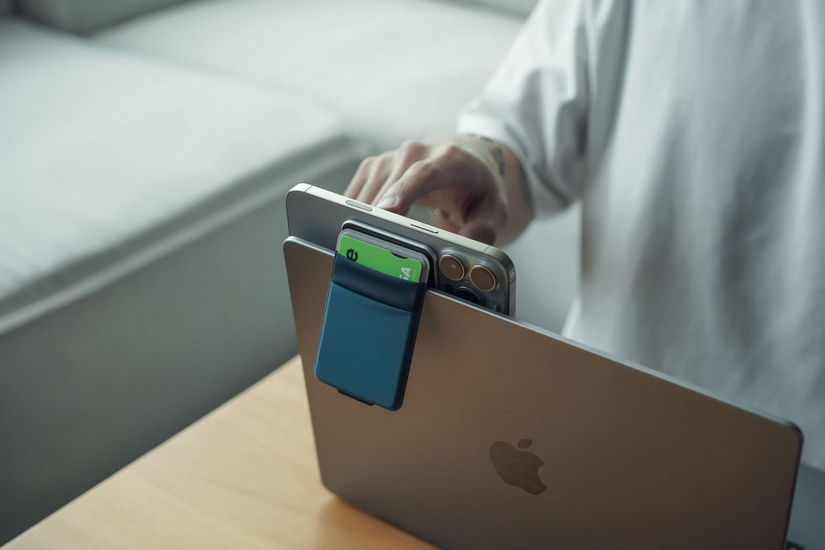 FlexiStand Plate in Blue propping up an iPhone on a desk